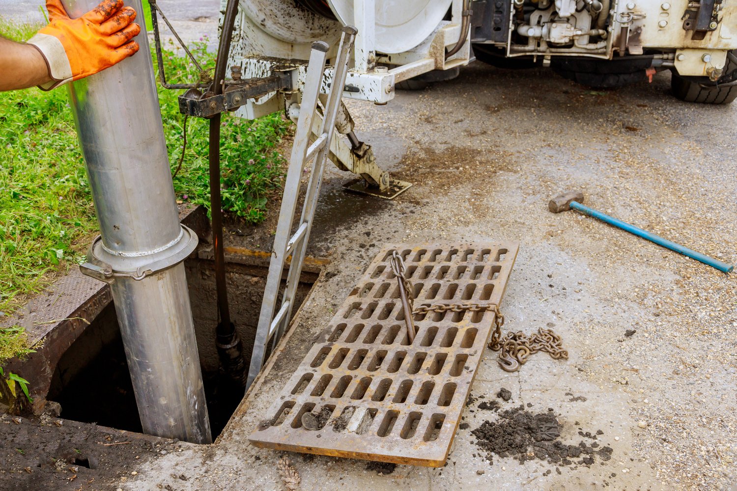 Worker Cleaning a Sewer System